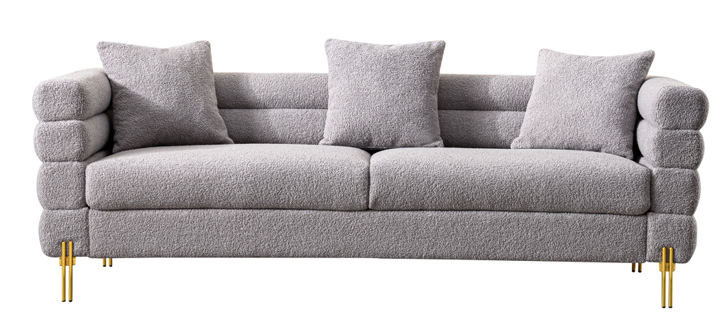 Luxurious and comfortable upholstered sofa with golden legs and pillows for living room and reception area